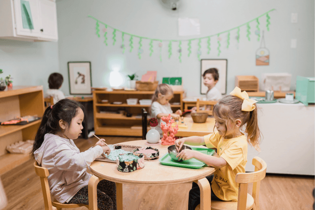 Primary students working together at a classroom table