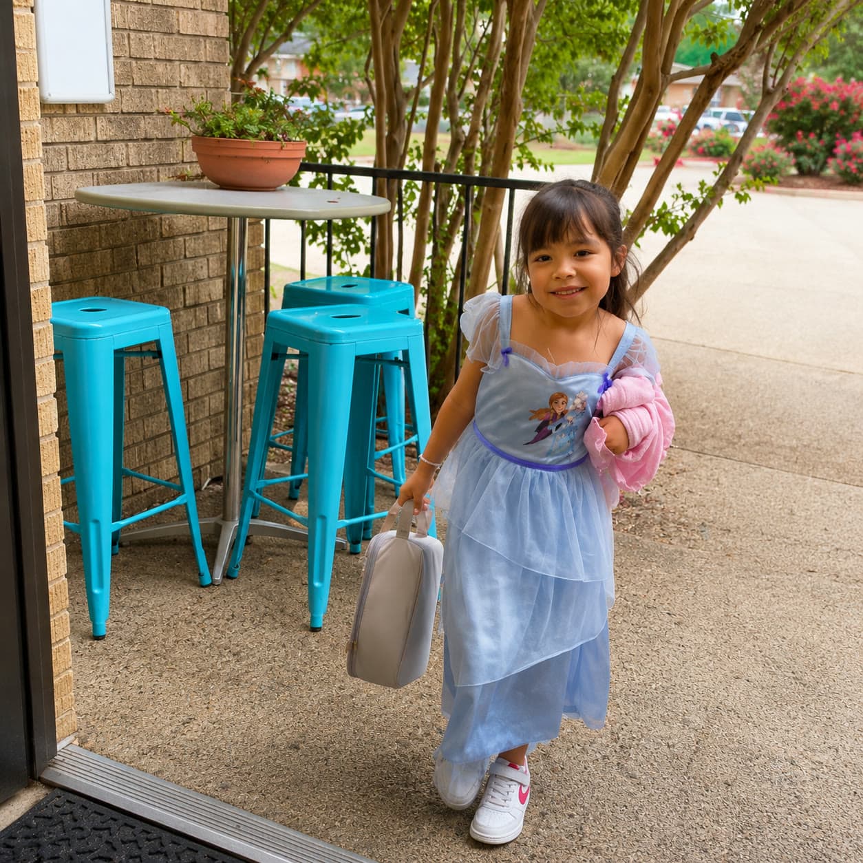 A child arriving and being greeted at Casa de Paz